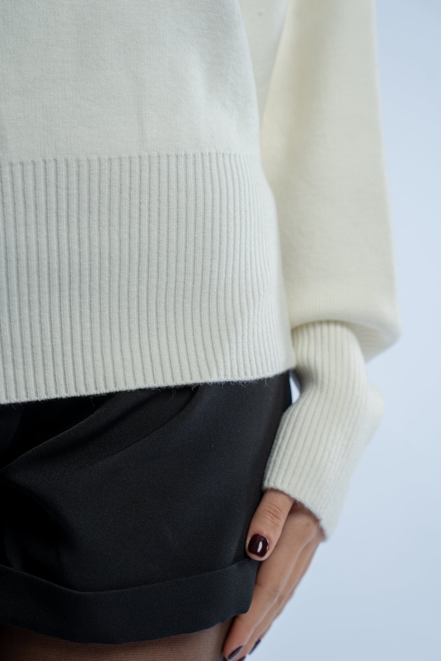 Asymmetrical waist-defined knit top